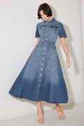 Woman wearing a blue denim dress against a white background