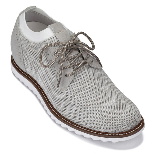 White sneaker with brown sole on a white background