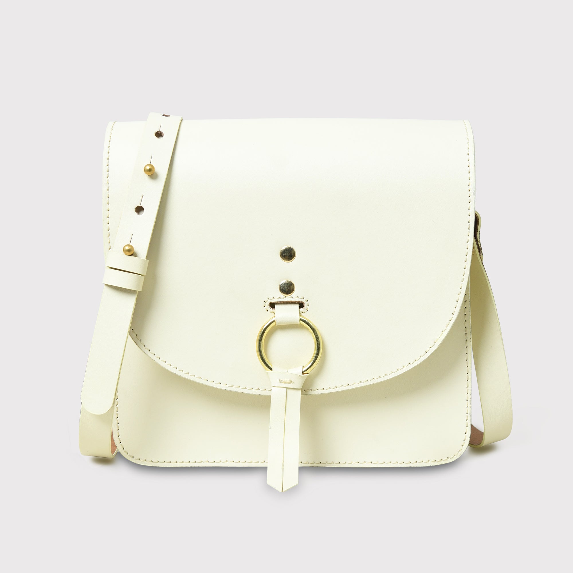 Cream-colored handbag with a gold ring on a light gray background