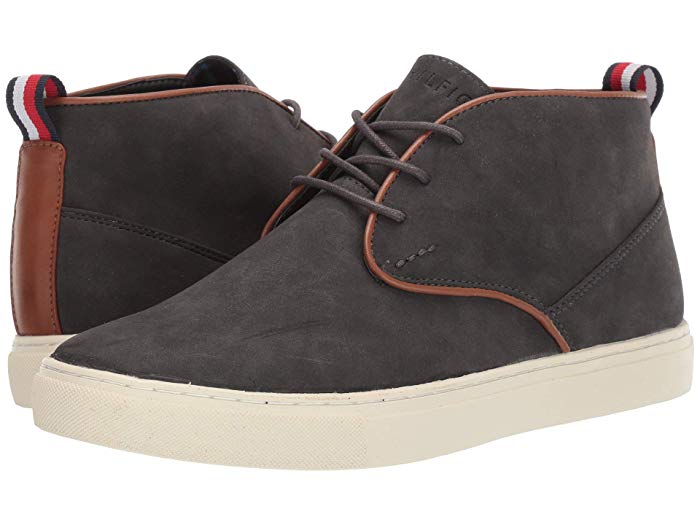 Pair of dark gray high-top sneakers with brown accents on a white background
