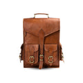 Brown leather backpack with gold buckles on a white background
