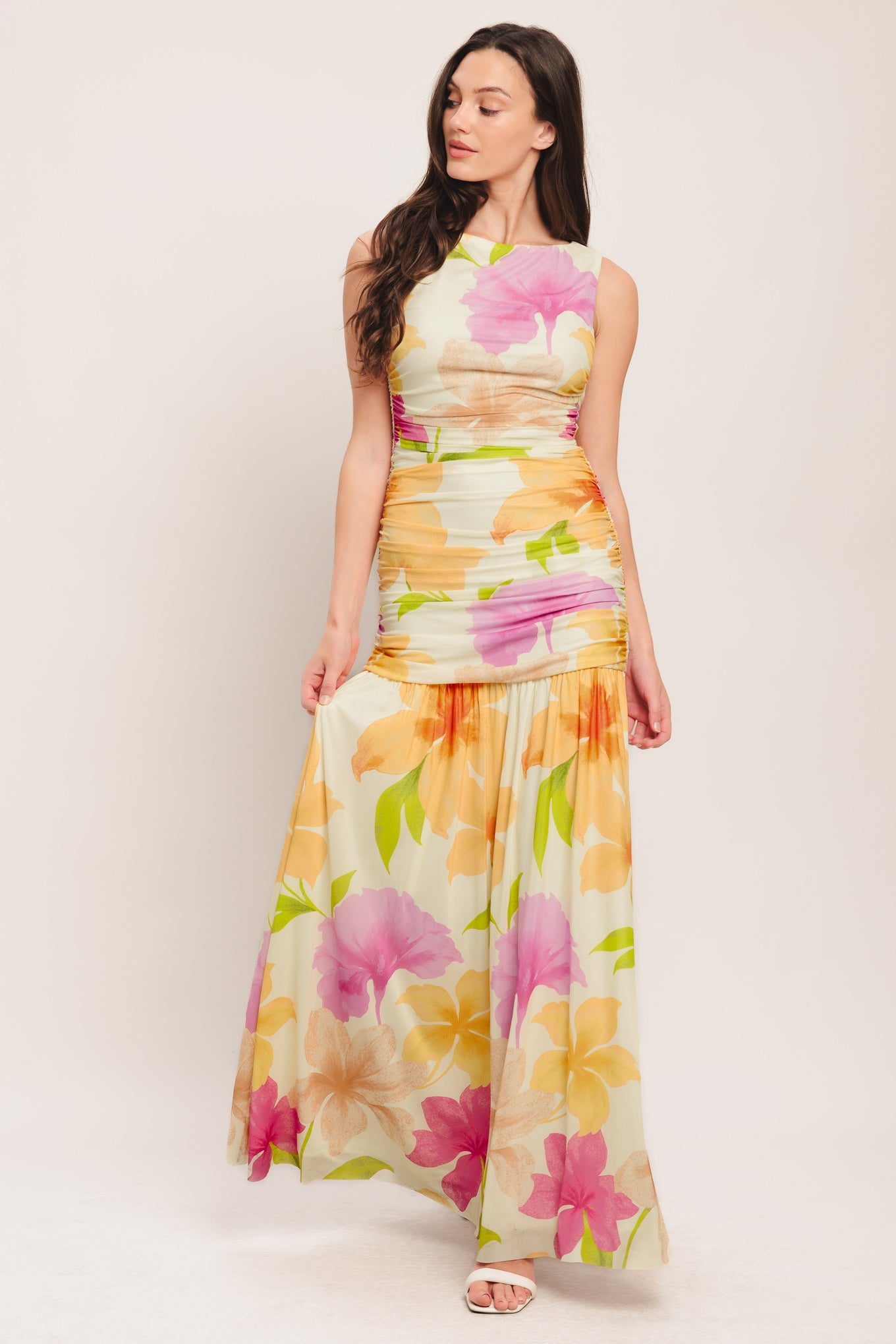 Woman wearing a floral dress on a plain background